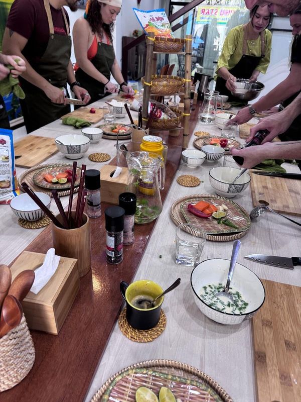 Group of participants cooking together during a Vietnamese cooking class at Family Kitchen Da Nang